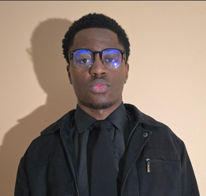 Christopher Wawa wearing glasses and a dark jacket
